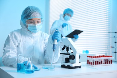 Photo of Medical analysis. Scientists working with samples in laboratory, selective focus