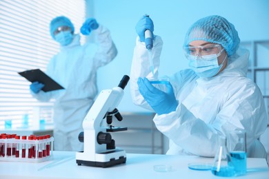 Photo of Medical analysis. Scientists working with samples in laboratory, selective focus