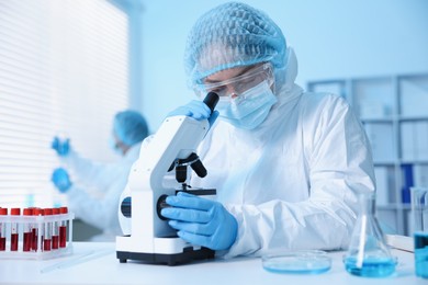 Photo of Medical analysis. Scientist working with microscope in laboratory, selective focus