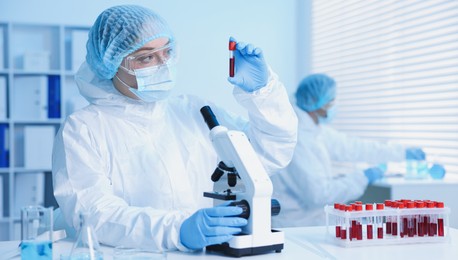 Photo of Medical analysis. Scientist working with blood sample in laboratory, selective focus