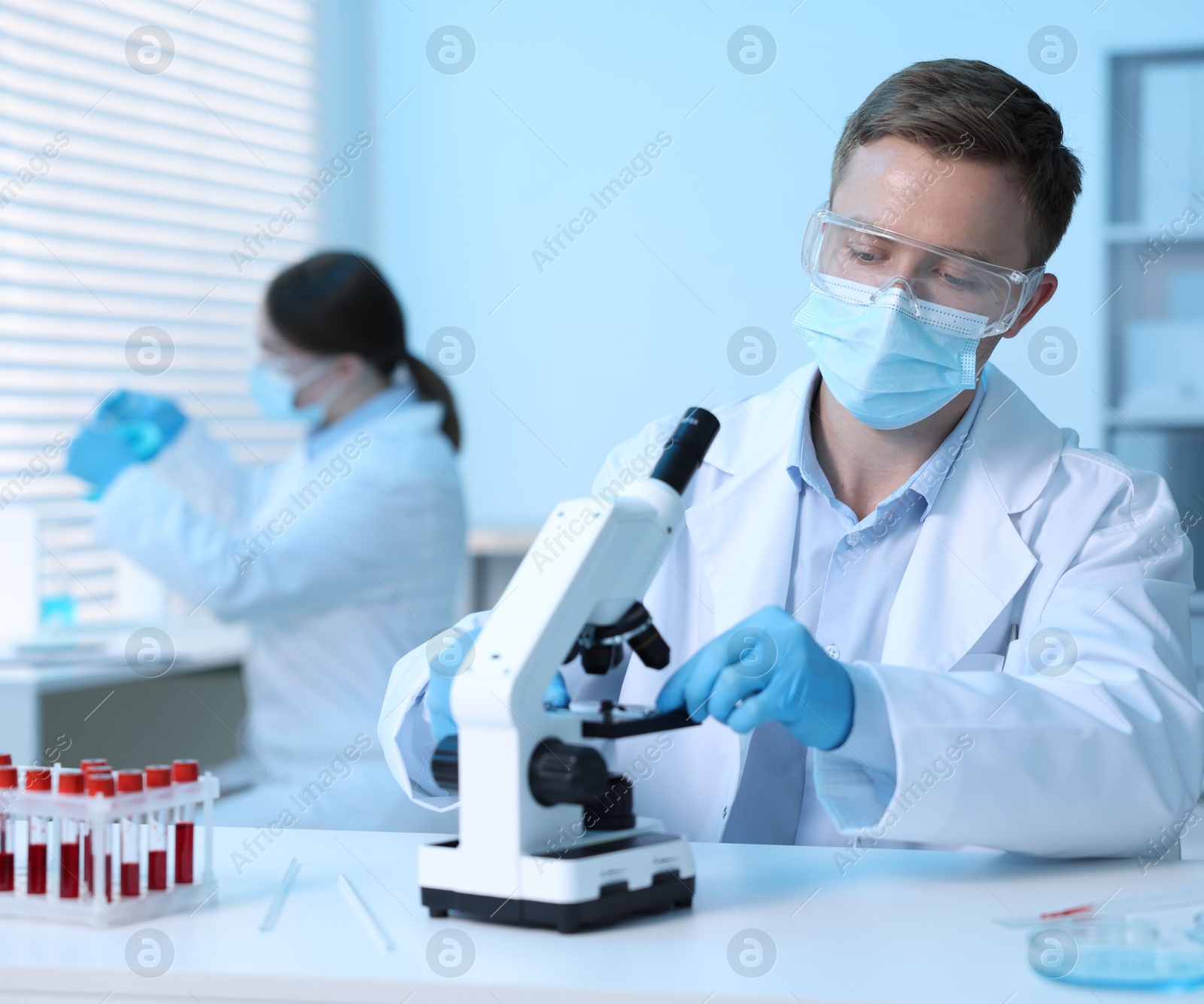 Medical analysis. Scientist working with microscope in laboratory, selective focus Photo of Medical analysis. Scientist working with microscope in laboratory, selective focus
