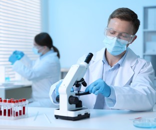 Photo of Medical analysis. Scientist working with microscope in laboratory, selective focus