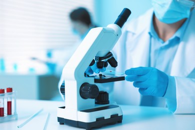 Photo of Medical analysis. Scientist working with microscope in laboratory, selective focus