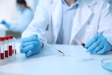 Photo of Medical analysis. Scientist working with blood sample in laboratory, selective focus