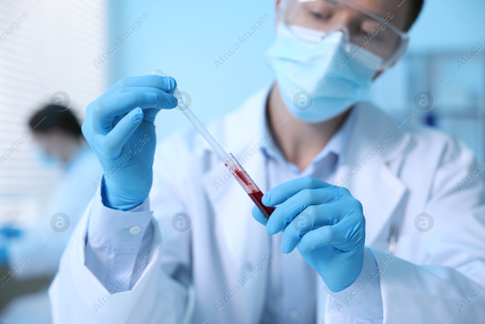 Medical analysis. Scientist working with blood sample in laboratory, selective focus Photo of Medical analysis. Scientist working with blood sample in laboratory, selective focus