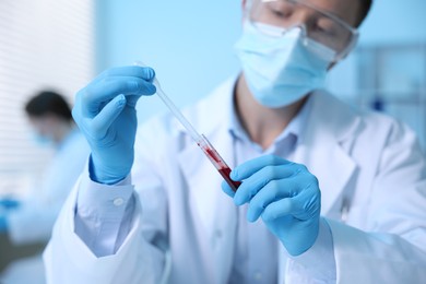 Photo of Medical analysis. Scientist working with blood sample in laboratory, selective focus