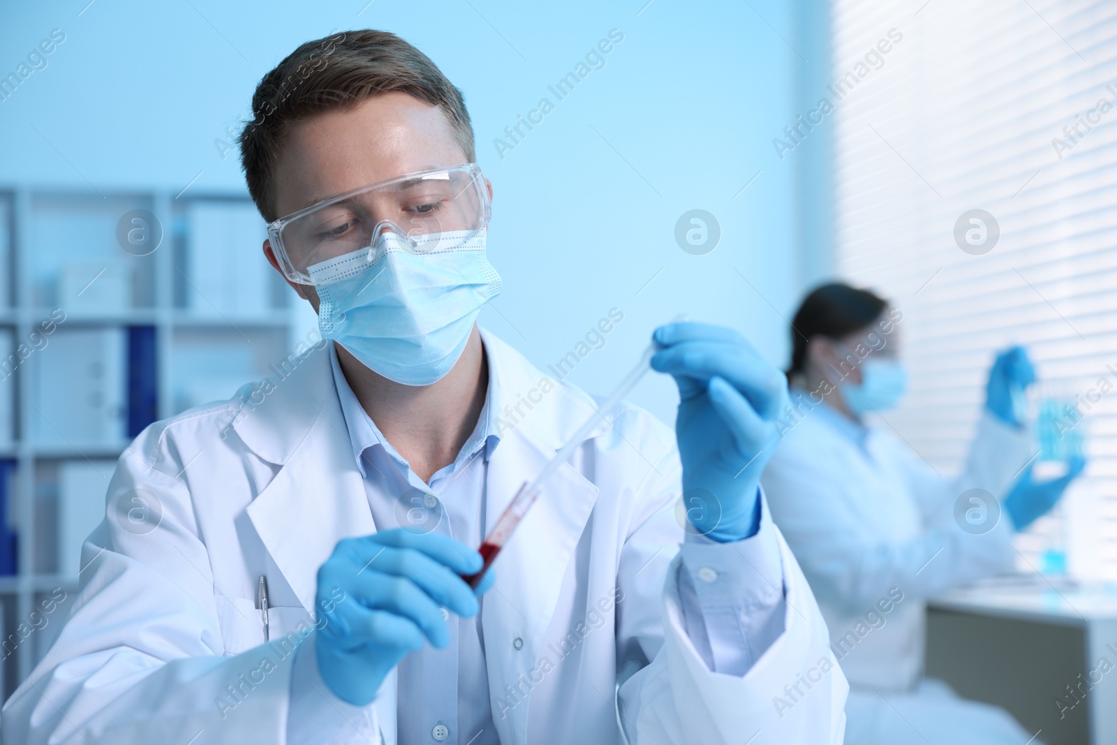 Medical analysis. Scientist working with blood sample in laboratory, selective focus Photo of Medical analysis. Scientist working with blood sample in laboratory, selective focus