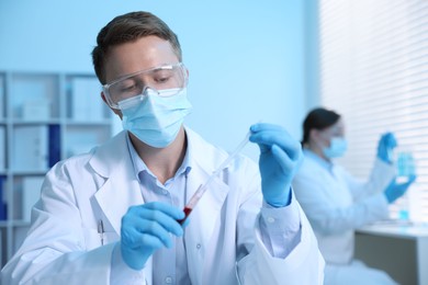 Photo of Medical analysis. Scientist working with blood sample in laboratory, selective focus
