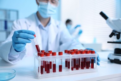 Photo of Medical analysis. Scientist working with blood sample in laboratory, selective focus