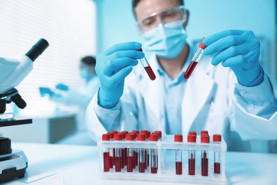 Photo of Medical analysis. Scientist working with blood samples in laboratory, selective focus