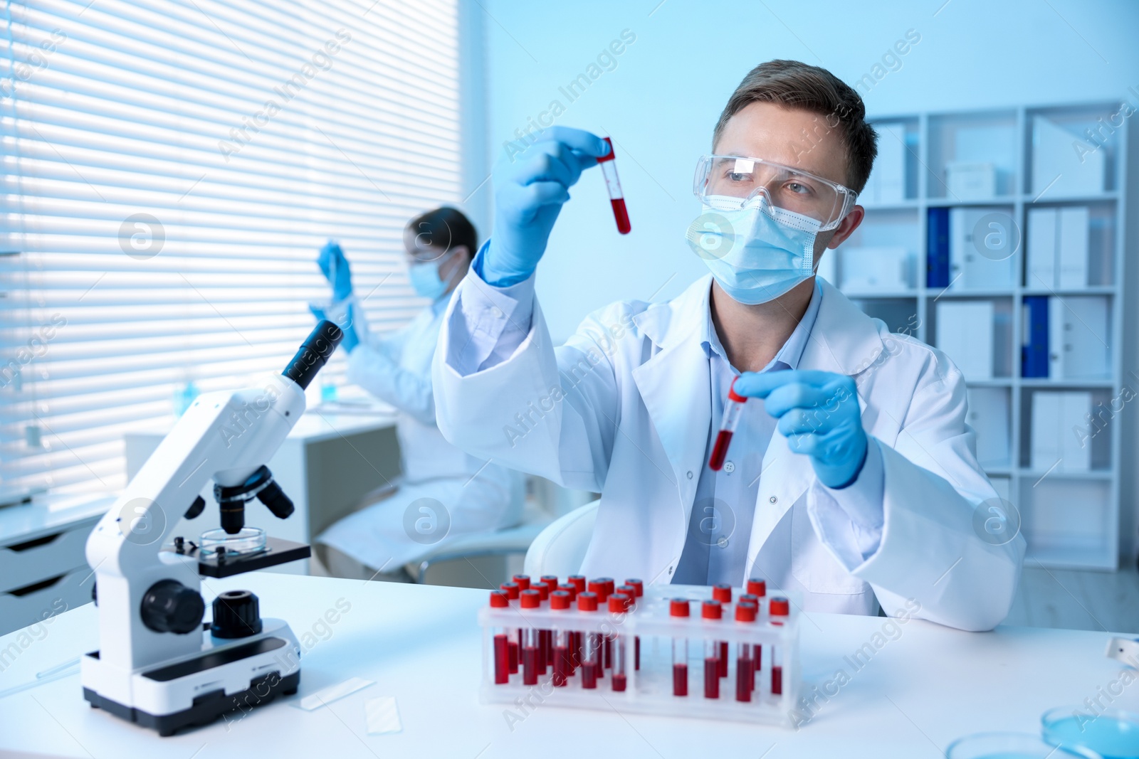 Medical analysis. Scientist working with blood samples in laboratory, selective focus Photo of Medical analysis. Scientist working with blood samples in laboratory, selective focus