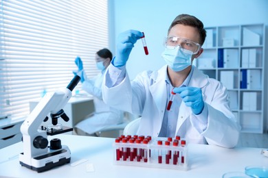 Photo of Medical analysis. Scientist working with blood samples in laboratory, selective focus