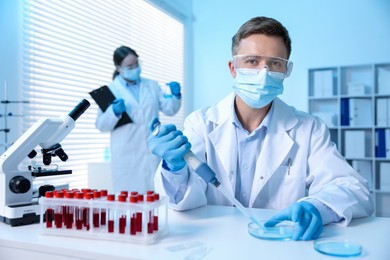 Photo of Medical analysis. Scientist working with sample in laboratory, selective focus