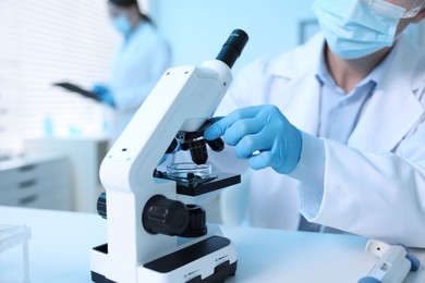 Photo of Medical analysis. Scientist working with microscope in laboratory, selective focus