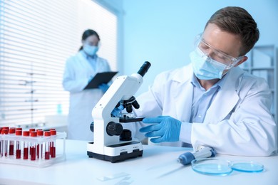 Photo of Medical analysis. Scientist working with microscope in laboratory, selective focus