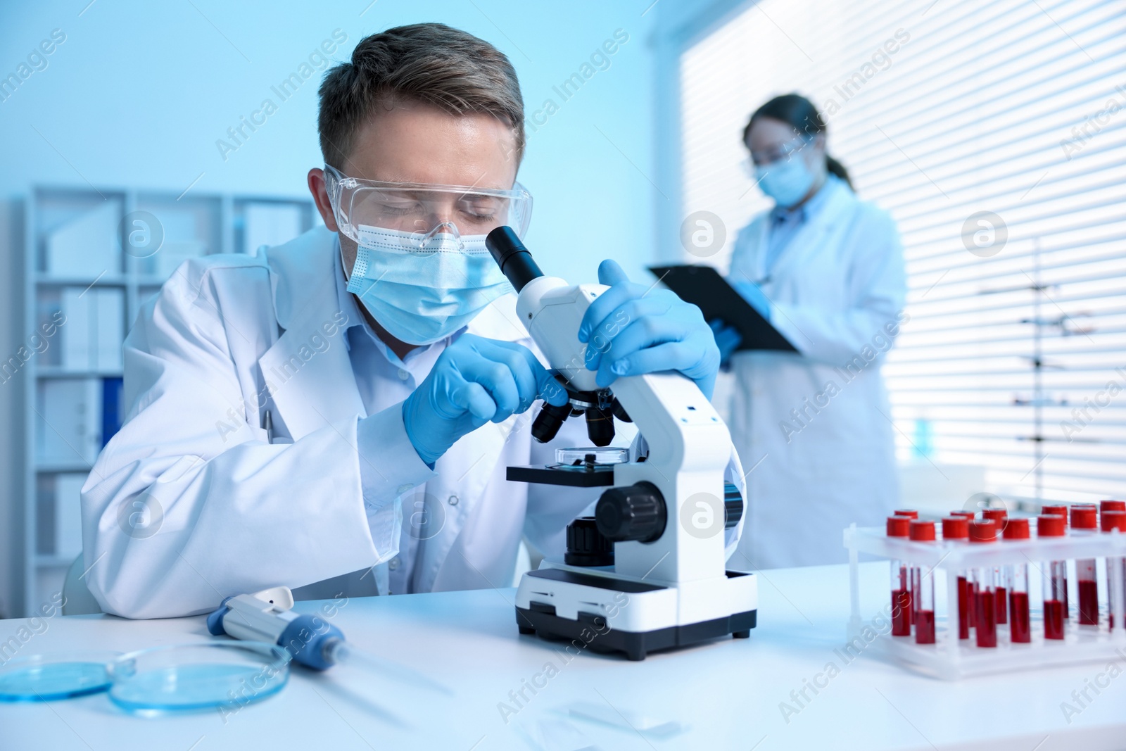 Medical analysis. Scientist working with microscope in laboratory, selective focus Photo of Medical analysis. Scientist working with microscope in laboratory, selective focus
