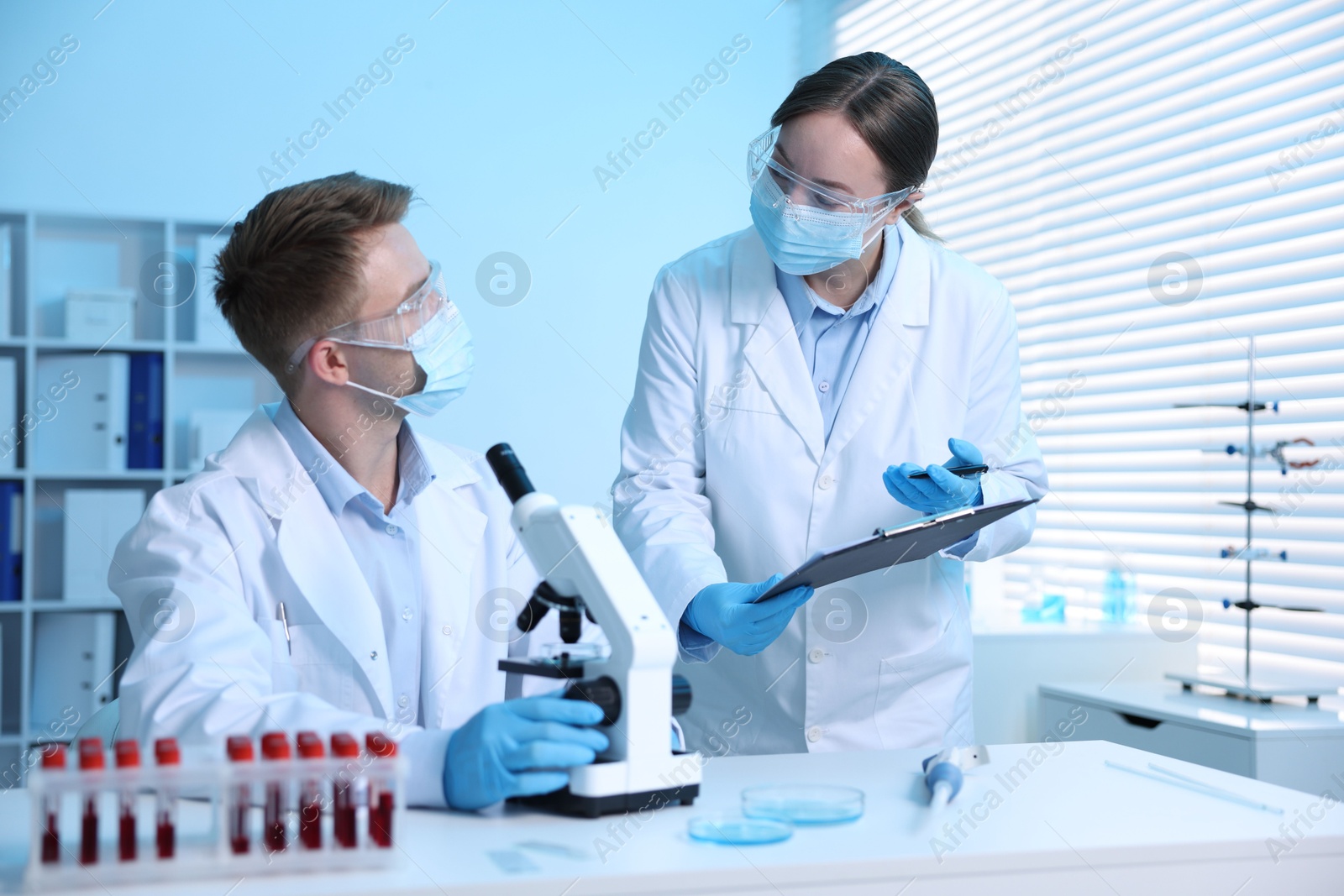 Medical analysis. Scientists working with microscope in laboratory Photo of Medical analysis. Scientists working with microscope in laboratory