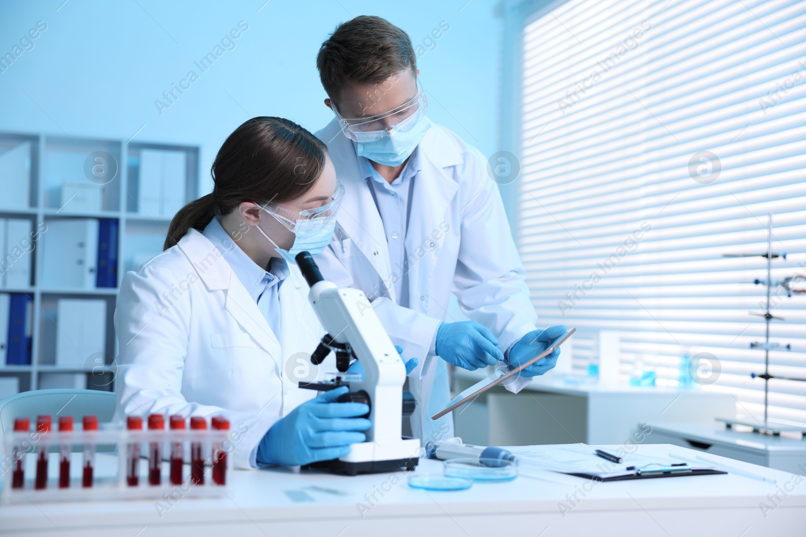 Medical analysis. Scientists working with microscope in laboratory Photo of Medical analysis. Scientists working with microscope in laboratory