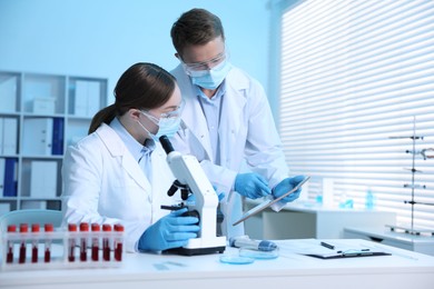 Photo of Medical analysis. Scientists working with microscope in laboratory
