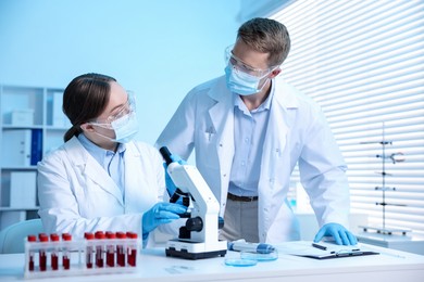 Photo of Medical analysis. Scientists working with microscope in laboratory