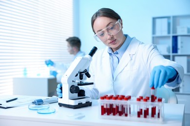 Photo of Medical analysis. Scientist working with blood sample in laboratory, selective focus