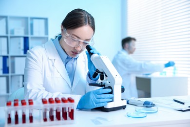 Photo of Medical analysis. Scientist working with microscope in laboratory, selective focus