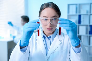 Photo of Medical analysis. Scientist working with blood samples in laboratory, selective focus