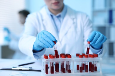 Photo of Medical analysis. Scientist working with blood samples in laboratory, selective focus