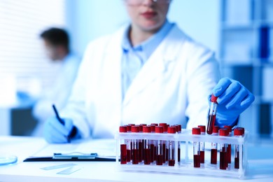 Photo of Medical analysis. Scientist working with blood sample in laboratory, selective focus