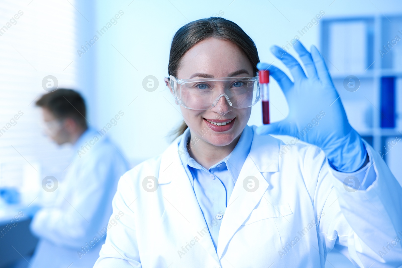 Medical analysis. Scientist working with blood sample in laboratory, selective focus Photo of Medical analysis. Scientist working with blood sample in laboratory, selective focus