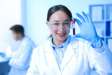 Photo of Medical analysis. Scientist working with blood sample in laboratory, selective focus
