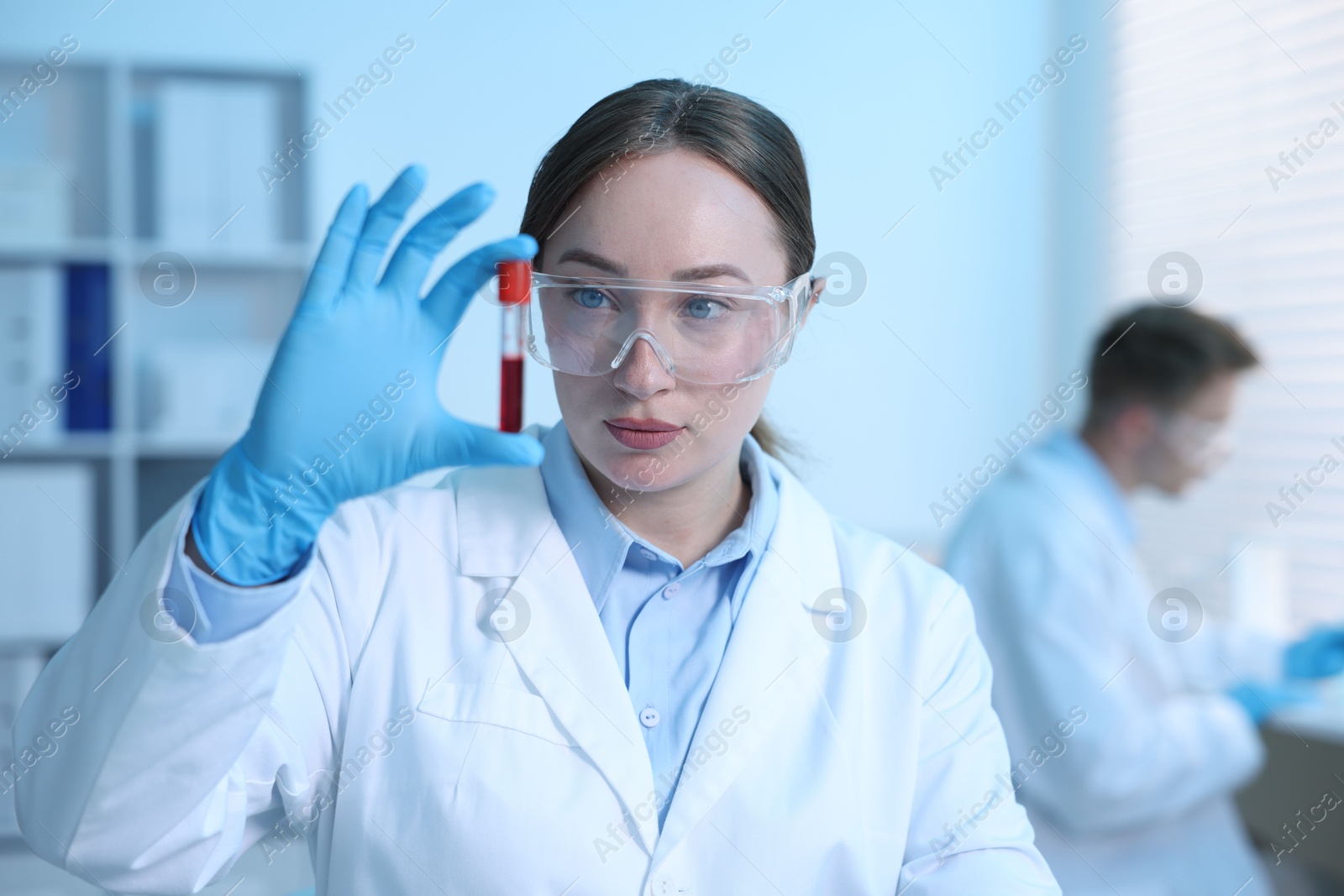 Medical analysis. Scientist working with blood sample in laboratory, selective focus Photo of Medical analysis. Scientist working with blood sample in laboratory, selective focus