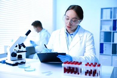 Photo of Medical analysis. Two scientists working in laboratory, selective focus