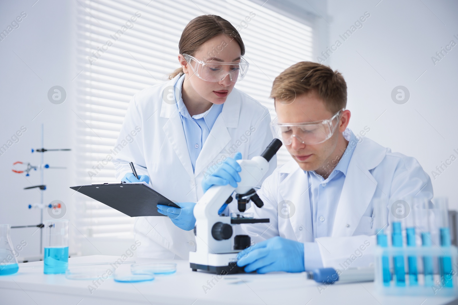 Medical analysis. Scientists working with microscope in laboratory Photo of Medical analysis. Scientists working with microscope in laboratory