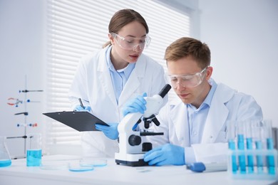Photo of Medical analysis. Scientists working with microscope in laboratory