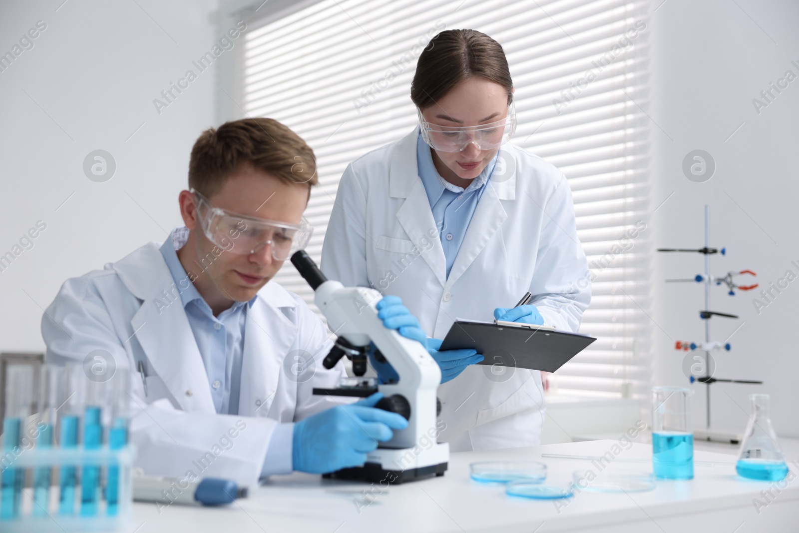 Medical analysis. Scientists working with microscope in laboratory Photo of Medical analysis. Scientists working with microscope in laboratory
