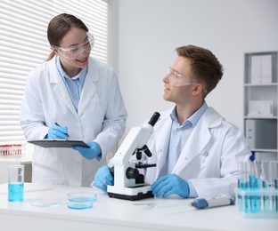 Photo of Medical analysis. Scientists working with microscope in laboratory