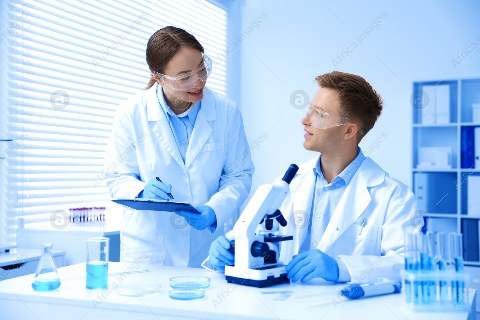 Medical analysis. Scientists working with microscope in laboratory Photo of Medical analysis. Scientists working with microscope in laboratory