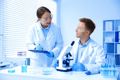 Photo of Medical analysis. Scientists working with microscope in laboratory
