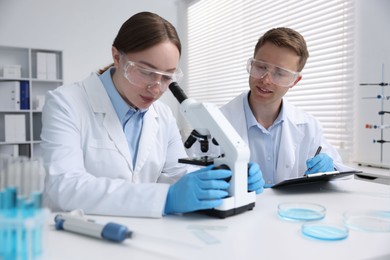 Photo of Medical analysis. Scientists working with microscope in laboratory