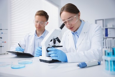 Photo of Medical analysis. Scientists working with microscope in laboratory
