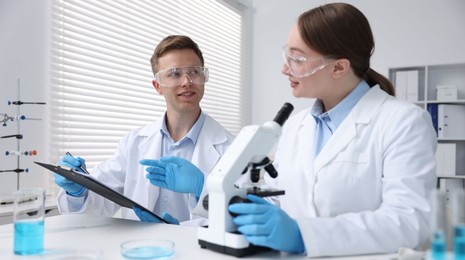 Photo of Medical analysis. Scientists working with microscope in laboratory