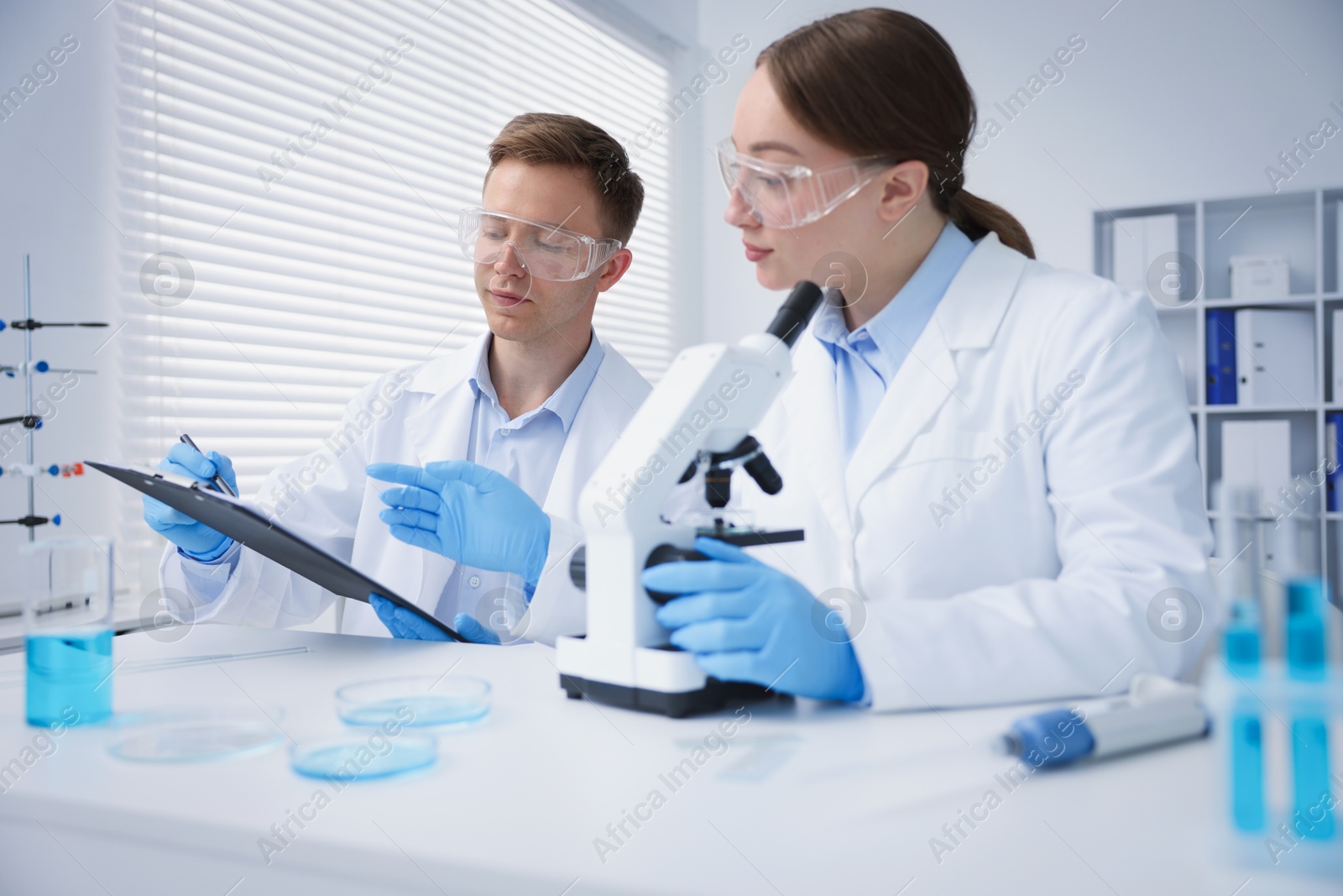Medical analysis. Scientists working with microscope in laboratory Photo of Medical analysis. Scientists working with microscope in laboratory