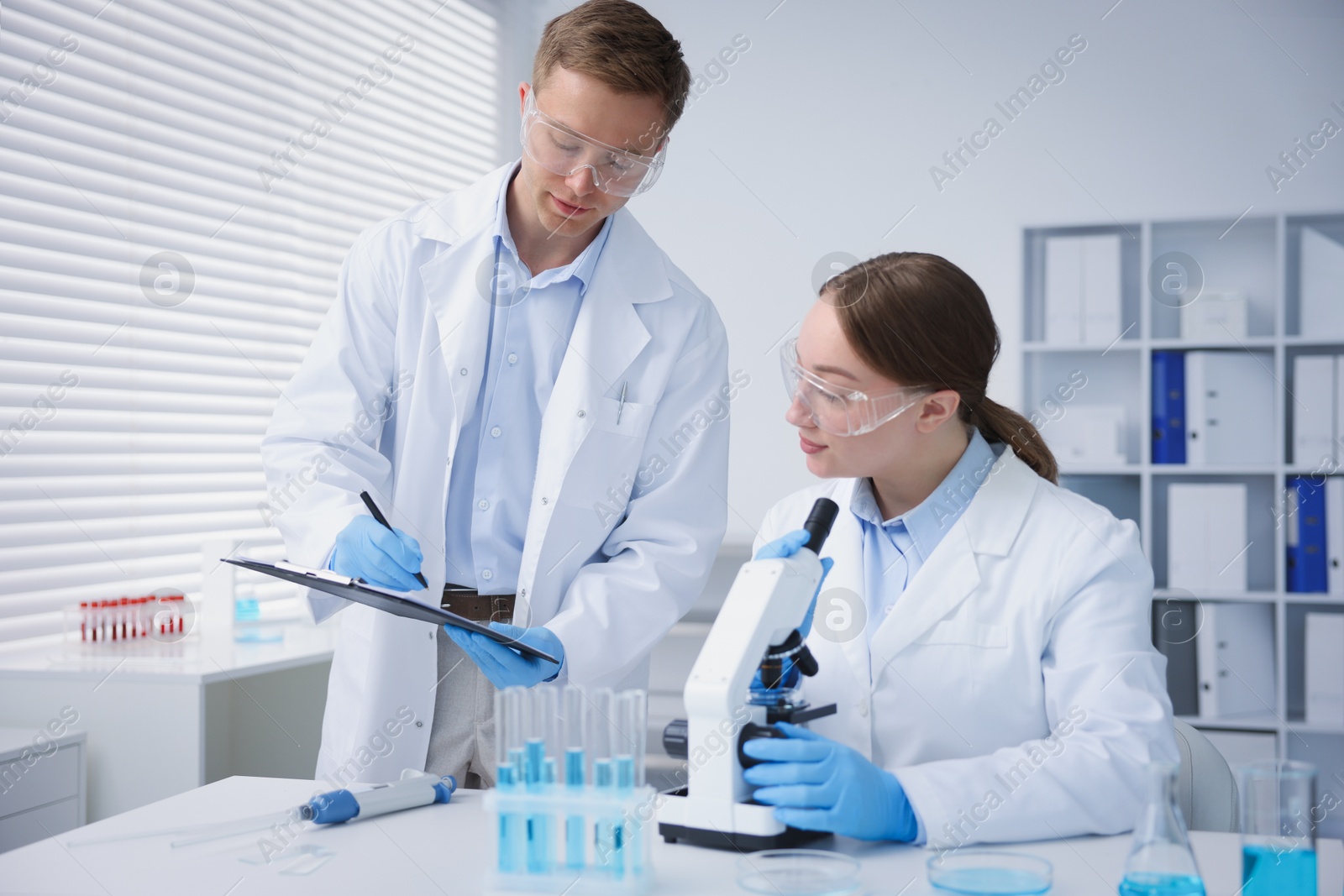 Medical analysis. Scientists working with microscope in laboratory Photo of Medical analysis. Scientists working with microscope in laboratory