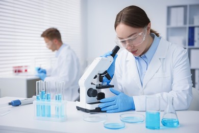 Photo of Medical analysis. Scientist working with microscope in laboratory, selective focus