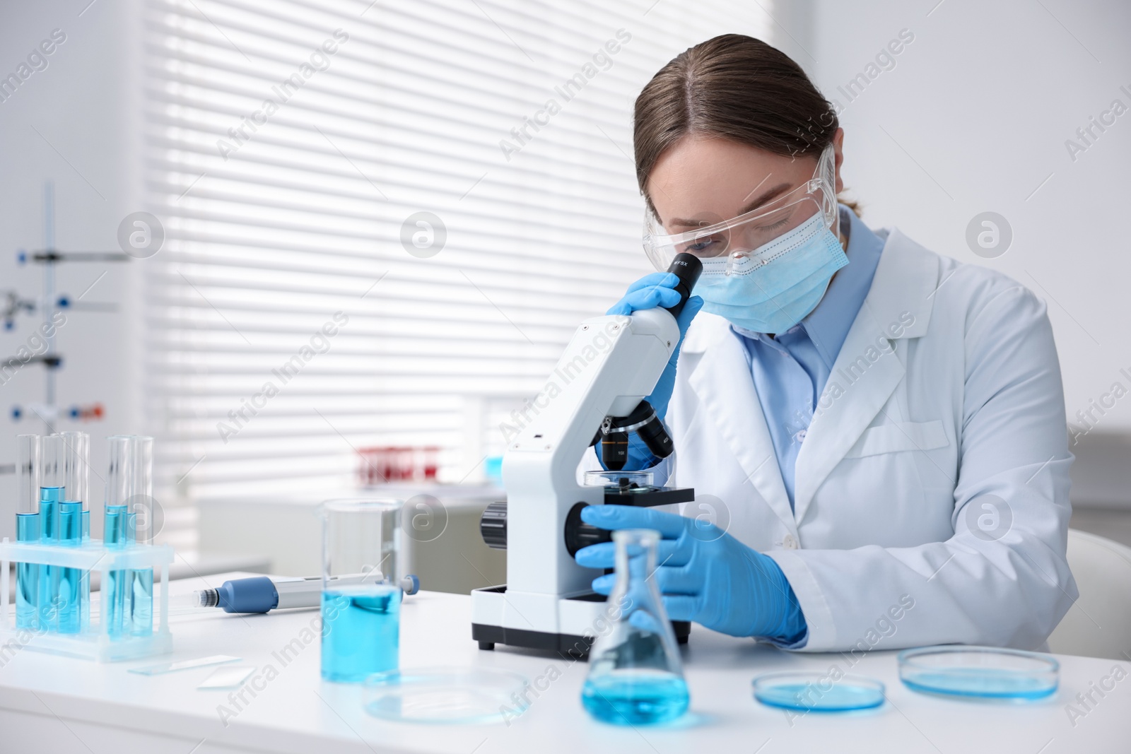 Medical analysis. Scientist working with microscope in laboratory Photo of Medical analysis. Scientist working with microscope in laboratory