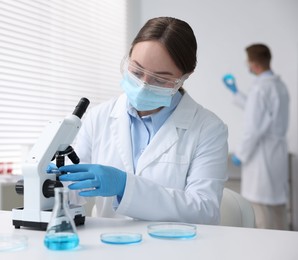 Photo of Medical analysis. Scientist working with microscope in laboratory, selective focus