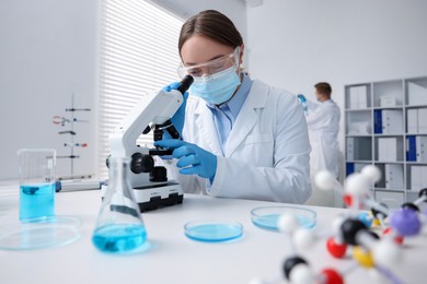 Photo of Medical analysis. Scientist working with microscope in laboratory, selective focus