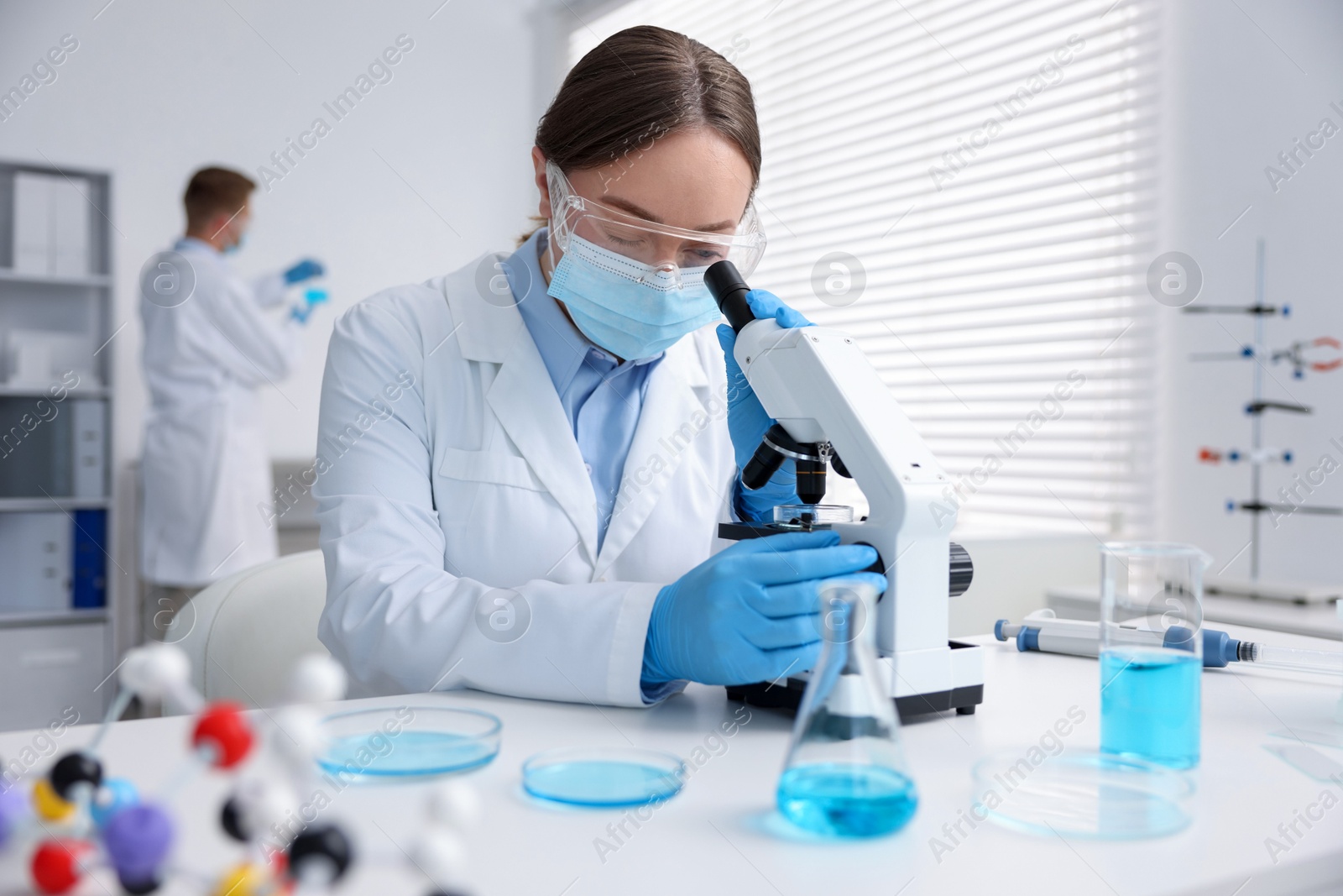 Medical analysis. Scientist working with microscope in laboratory, selective focus Photo of Medical analysis. Scientist working with microscope in laboratory, selective focus