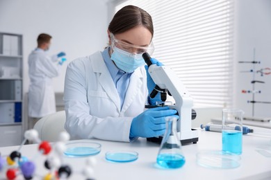 Photo of Medical analysis. Scientist working with microscope in laboratory, selective focus